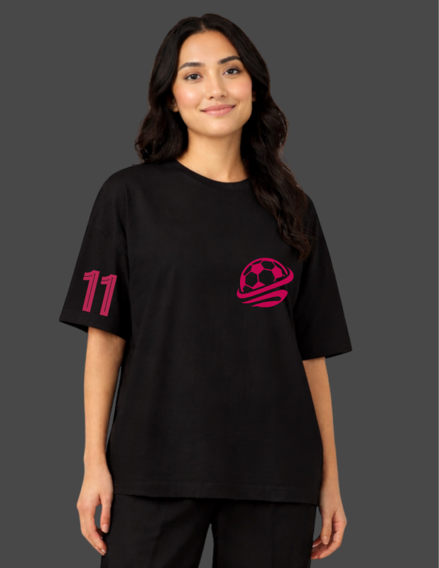 Person wearing a black t-shirt with pink numbers and logo on a dark background