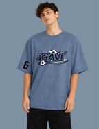Person wearing a blue t-shirt with a logo and text on a plain background