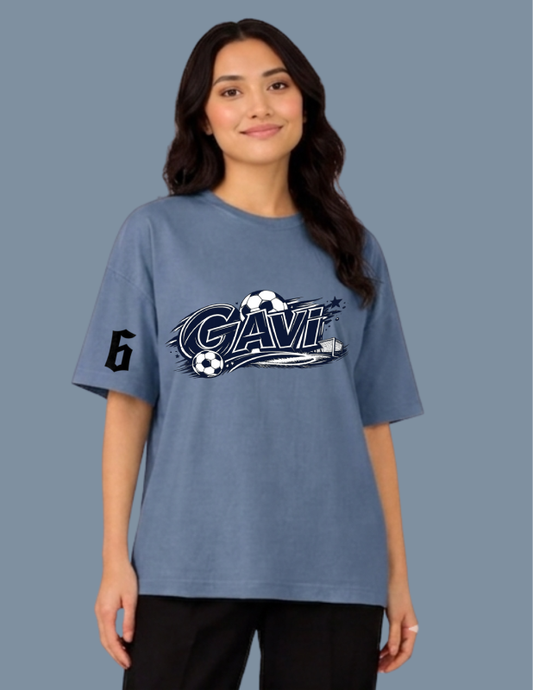 Person wearing a blue t-shirt with 'Gavi' logo on a plain background