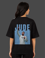 Person wearing a black t-shirt with a graphic of a person in a white jersey and 'JUDE' text on the back.