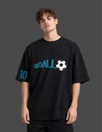 Person wearing a black t-shirt with 'GOALL' and a soccer ball design on a dark background