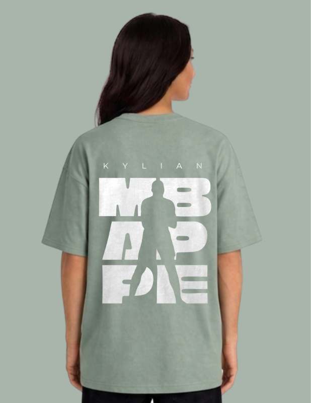 Person wearing a green t-shirt with white text and silhouette on a gray background