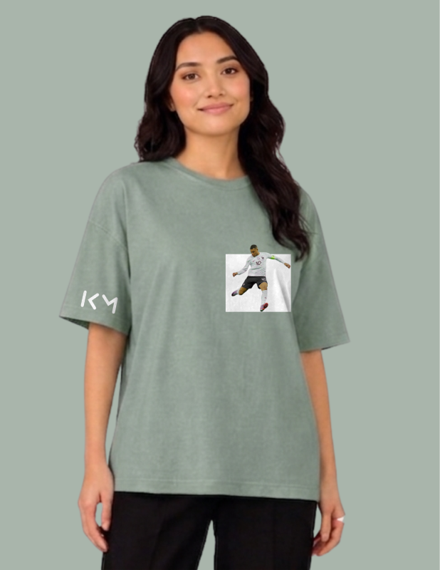 Person wearing a green t-shirt with a graphic and text on a gray background