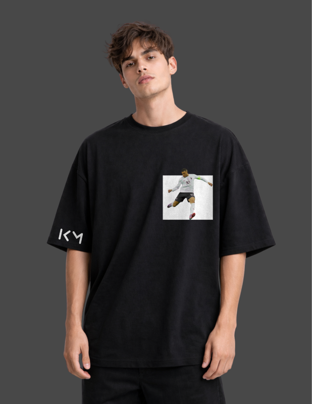 Person wearing a black t-shirt with a graphic design on a dark background