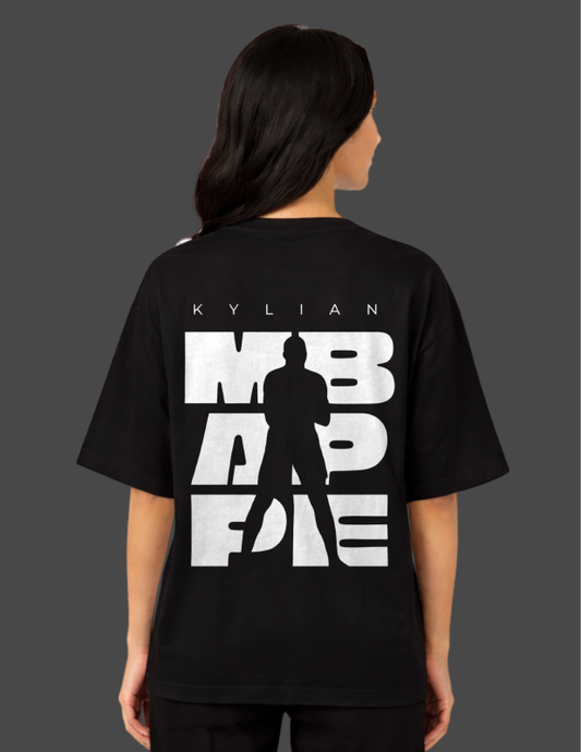 Person wearing a black t-shirt with white text and silhouette on the back, on a dark background