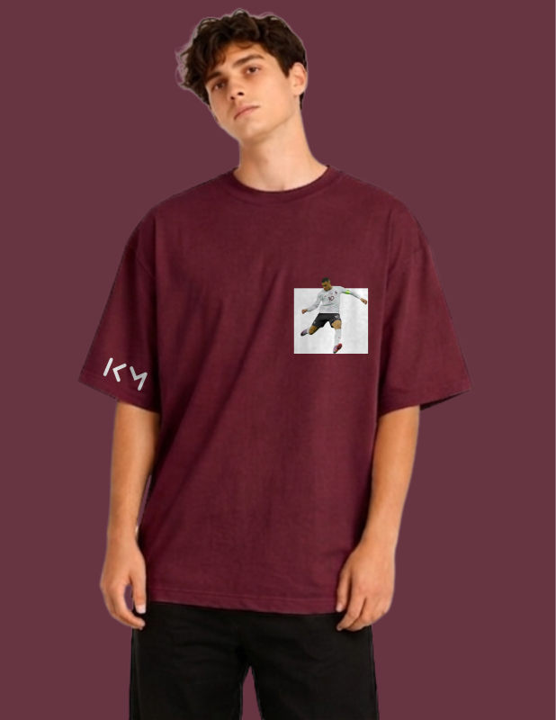 Person wearing a maroon t-shirt with a graphic design on a purple background