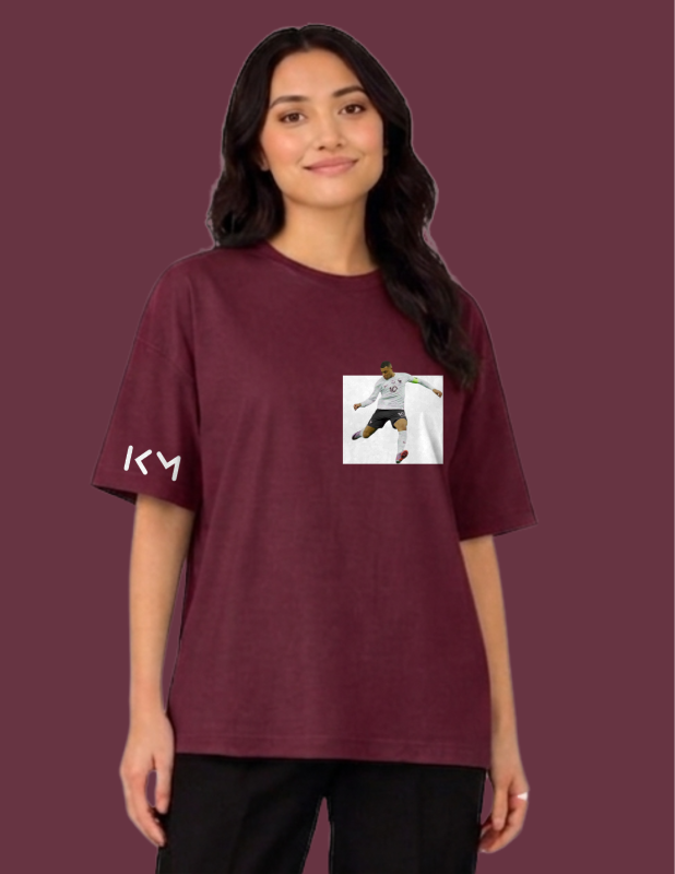 Person wearing a maroon t-shirt with a graphic design on a dark red background