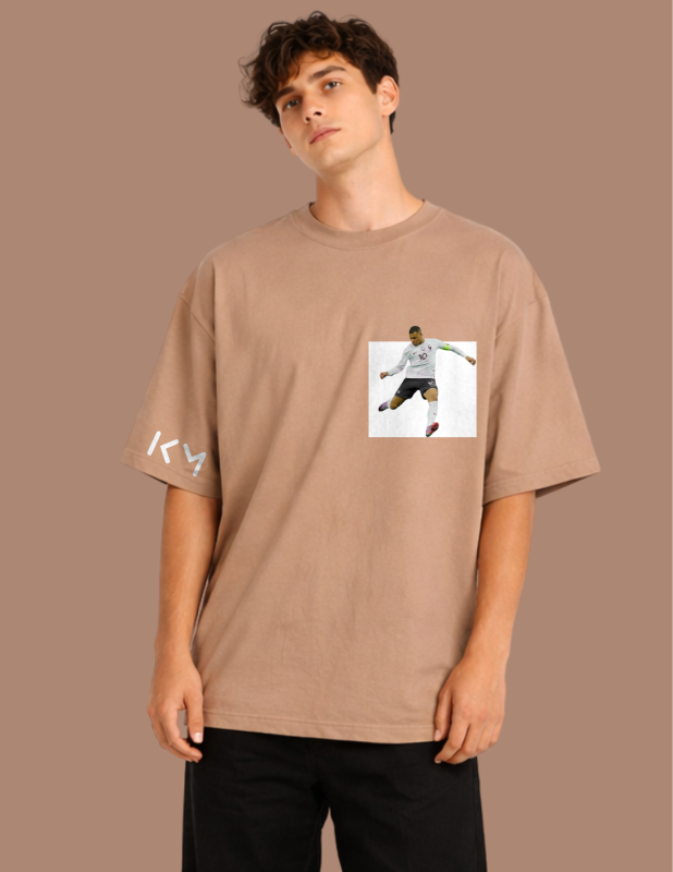 Man wearing a brown t-shirt with a graphic design on a brown background
