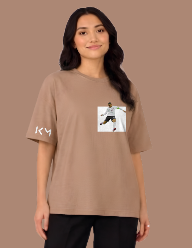 Woman wearing a brown t-shirt with a graphic and text on a brown background