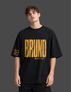 Person wearing a black t-shirt with 'BRUNO' printed in gold on a dark background