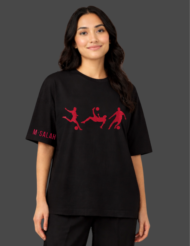 Person wearing a black t-shirt with red graphics and text on a dark background
