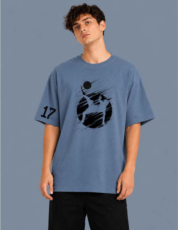 Person wearing a blue t-shirt with a graphic design on a gray background
