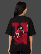 Person wearing a black t-shirt with a red graphic of a soccer player and the number 11 on the back.