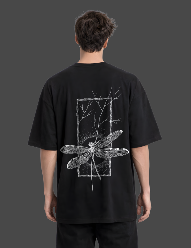 Person wearing a black t-shirt with a white dragonfly design on the back against a dark background