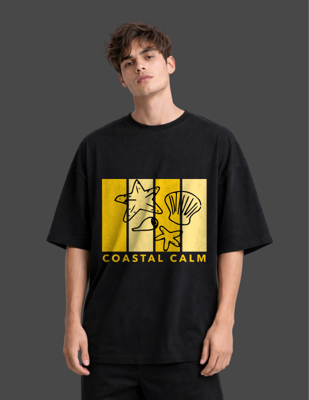 Person wearing a black t-shirt with a yellow graphic and 'Coastal Calm' text on a dark background