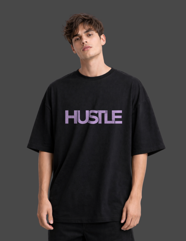 Person wearing a black t-shirt with 'HUSTLE' in purple on a dark background