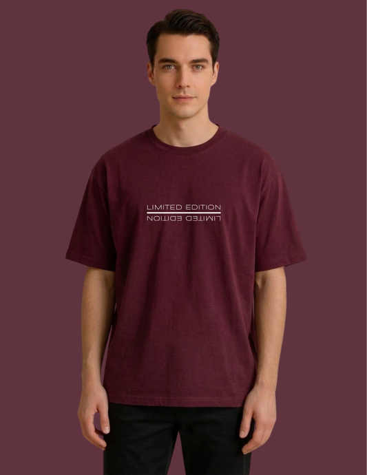 Man wearing a maroon t-shirt against a matching background