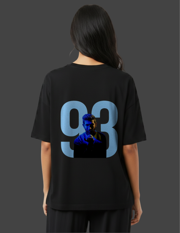 Person wearing a black t-shirt with a graphic design on the back