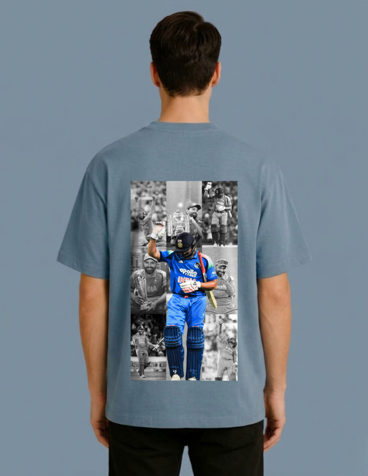 Person wearing a gray t-shirt with a graphic of a cricket player on the back against a solid background