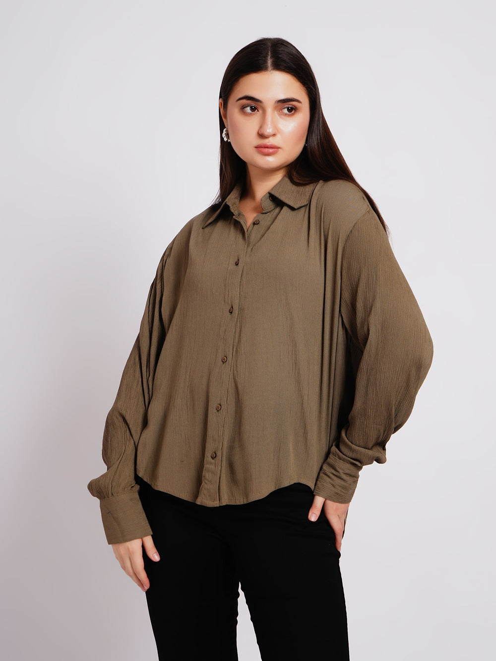 Woman wearing a brown blouse against a white background