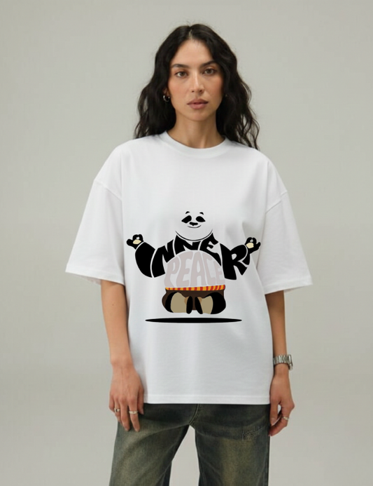 Person wearing a white t-shirt with a graphic design on a plain background